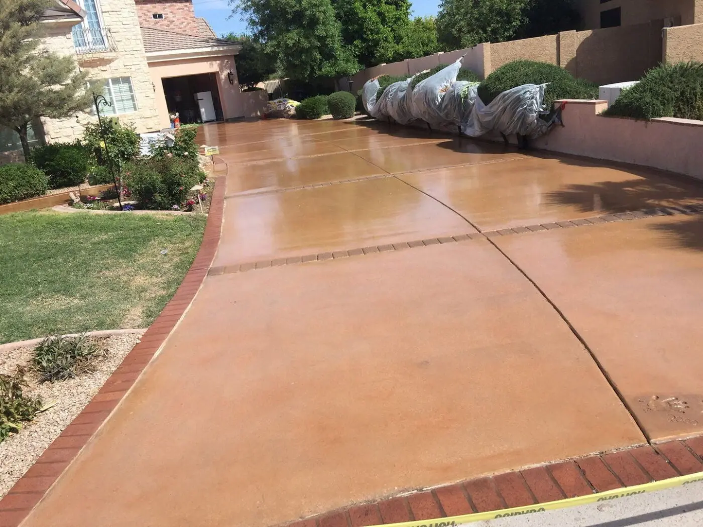 stained concrete driveway in an orange color in front of a home in Sparks NV