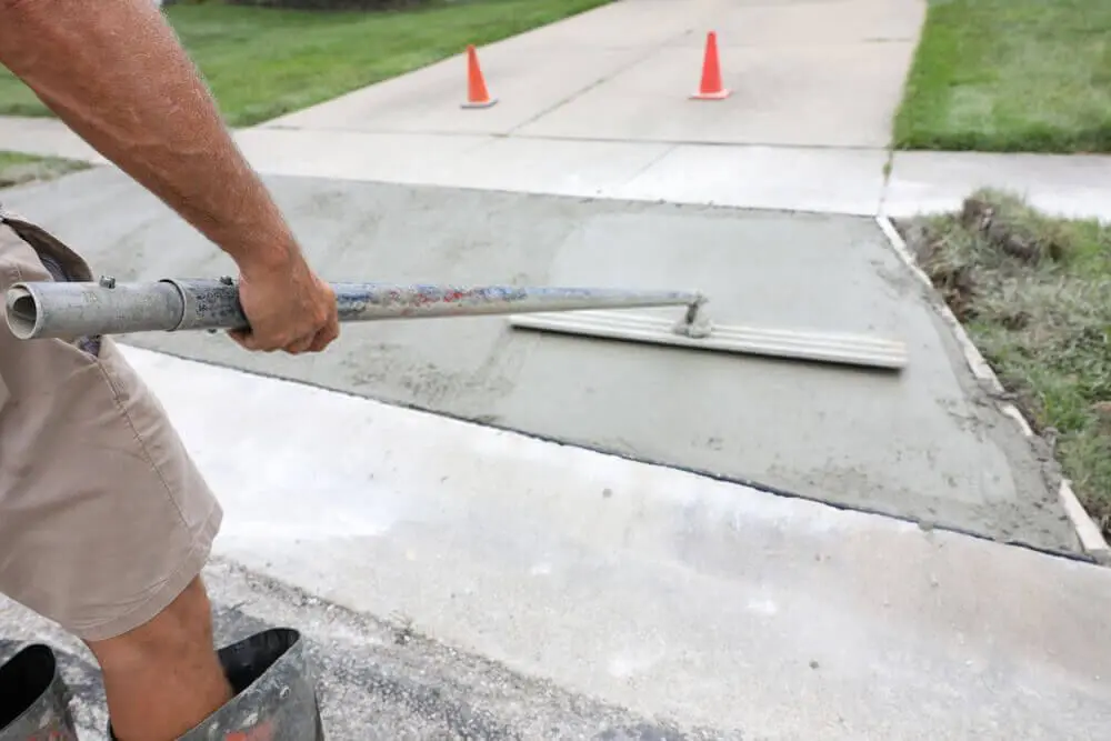 local contractor leveling this newly poured concrete slab driveway in Carson City, NV