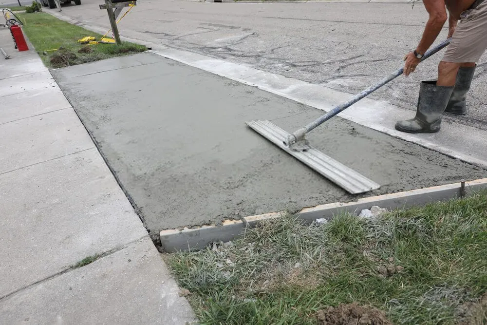 local contractor leveling this newly installed slop concrete slab driveway in Minden, NV